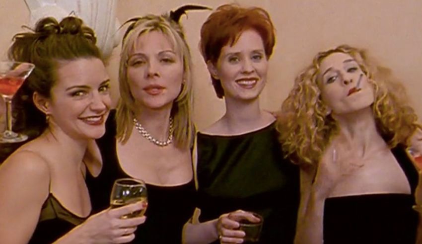 A group of women in black dresses posing for a picture.