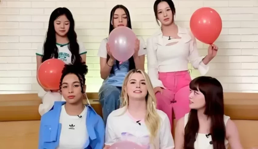 A group of girls holding balloons while sitting on a bench.