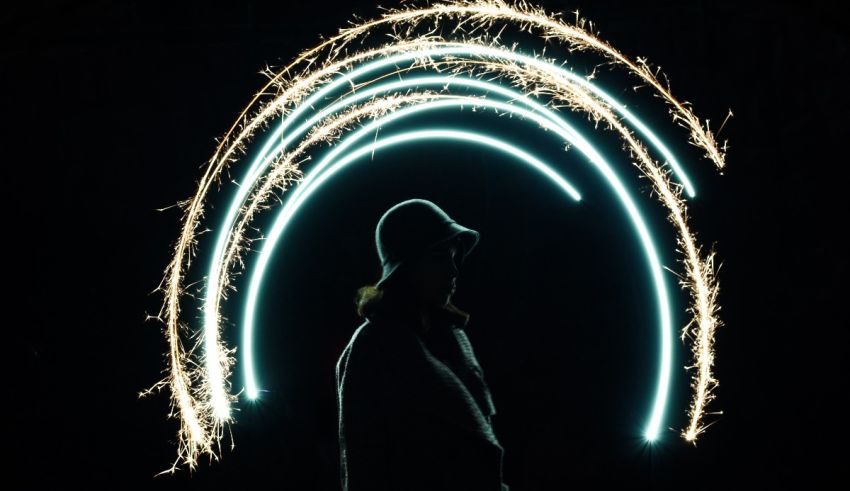 A person standing in front of a circle of sparklers.