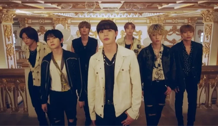 A group of korean boys standing in front of an ornate building.