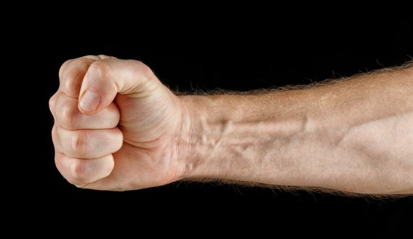 A man's fist on a black background.