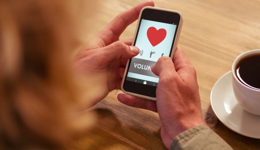 A woman holding a cell phone with a heart on it.