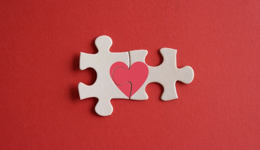 A puzzle piece with a heart on it on a red background.