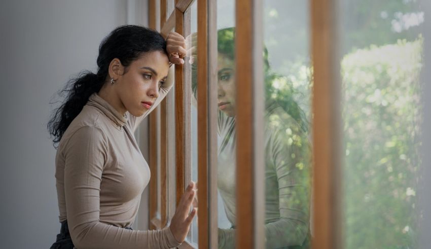 A young woman looking out of a window.