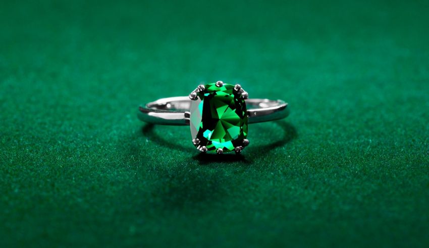An emerald ring on a green surface.