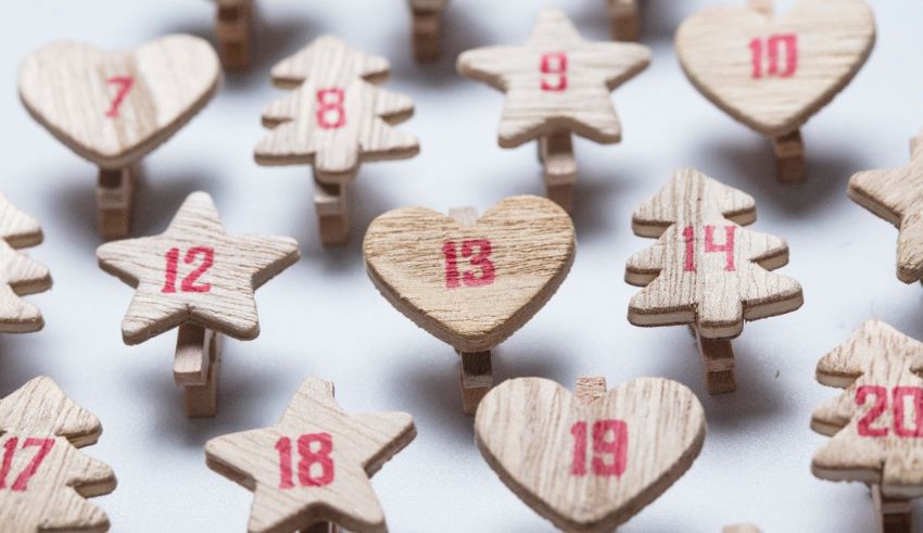 Wooden advent calendars hanging on clothespins.