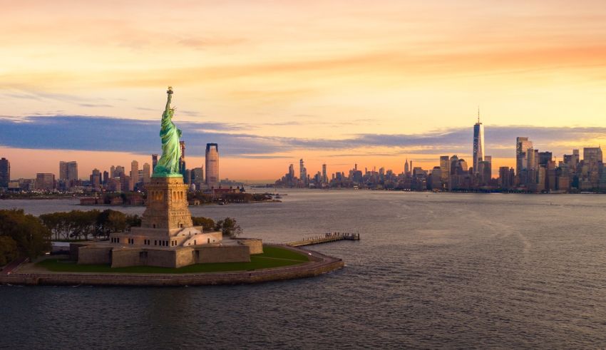 The statue of liberty in new york city at sunset.