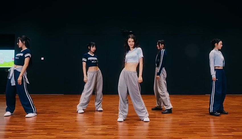 A group of people standing on a wooden floor.