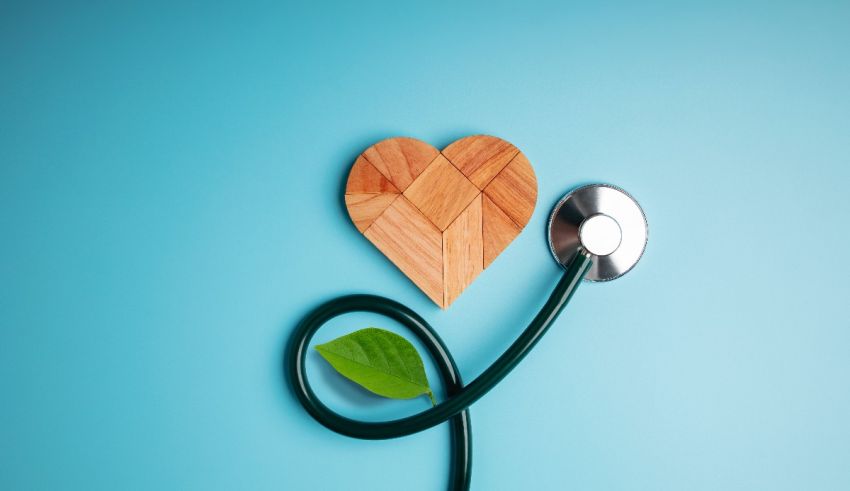 A wooden heart with a stethoscope on a blue background.