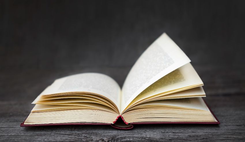 An open book on a wooden table.