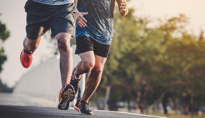 Two men jogging on a road.