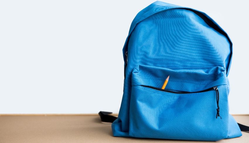 A blue backpack with a pencil on it.