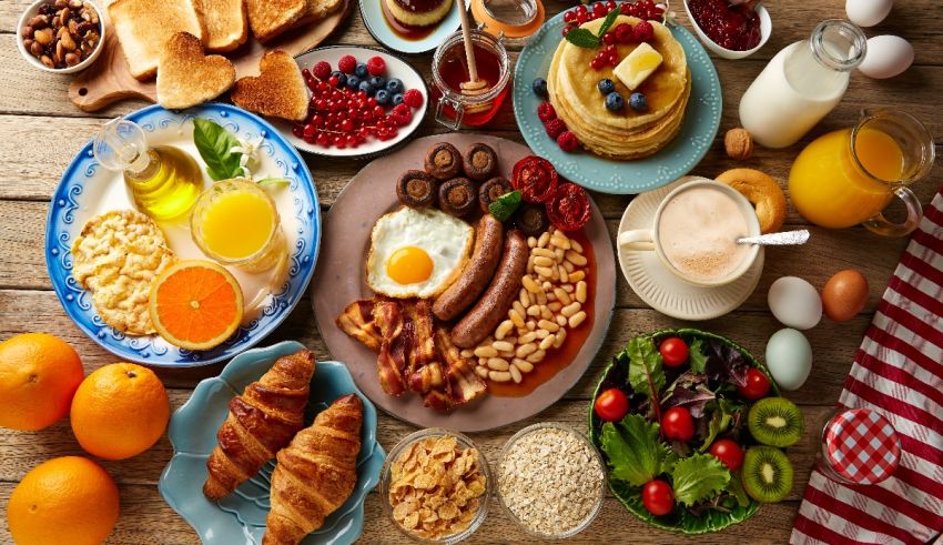 A variety of breakfast foods are arranged on a table.