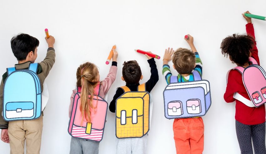 A group of children holding backpacks in front of a white wall.