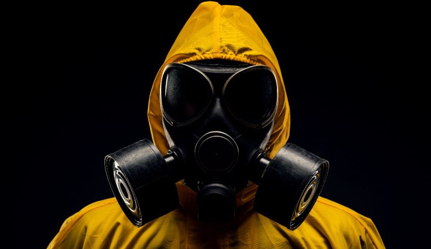 A man in a yellow gas mask on a black background.