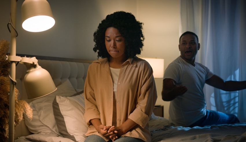 A man and woman standing on a bed in the middle of the night.