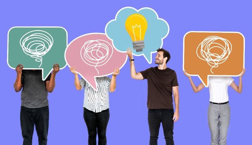 A group of people holding up light bulb speech bubbles.
