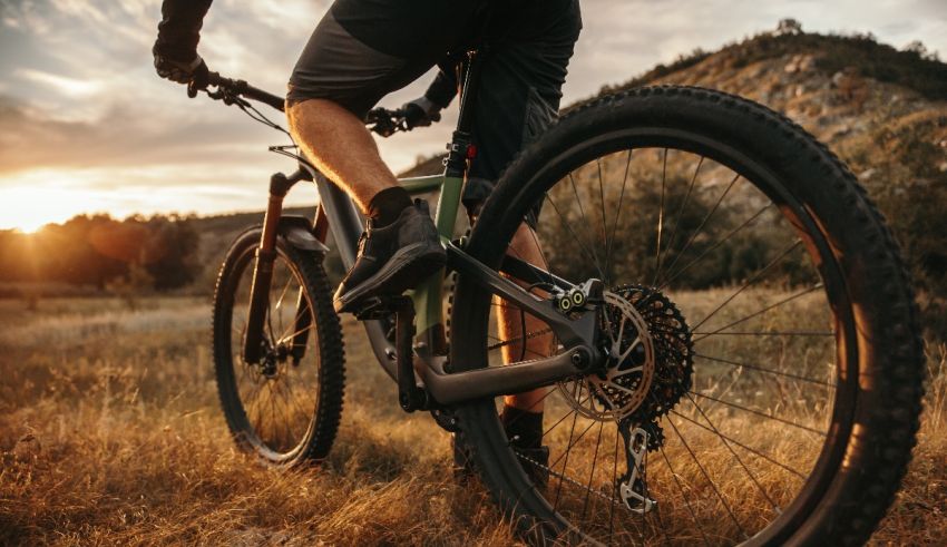 A man riding a mountain bike at sunset.