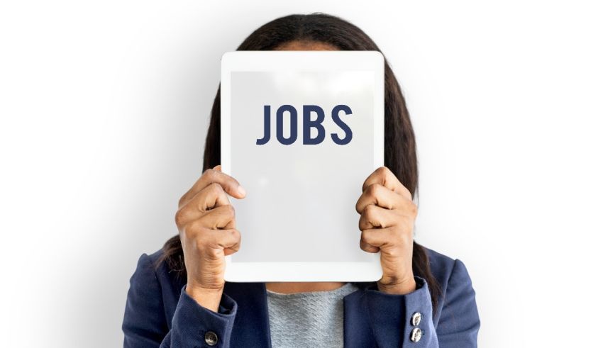 A woman holding up a tablet with the word jobs on it.