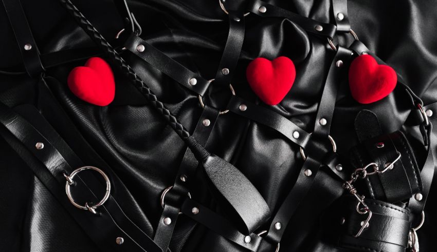 A black leather strap with red hearts on it.