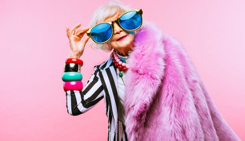 An older woman wearing sunglasses and a fur coat.