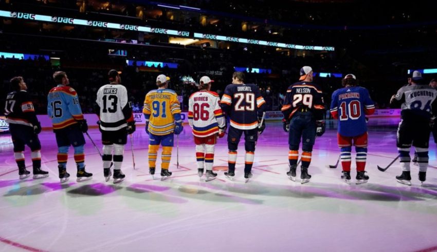A group of hockey players are standing on a ice rink.