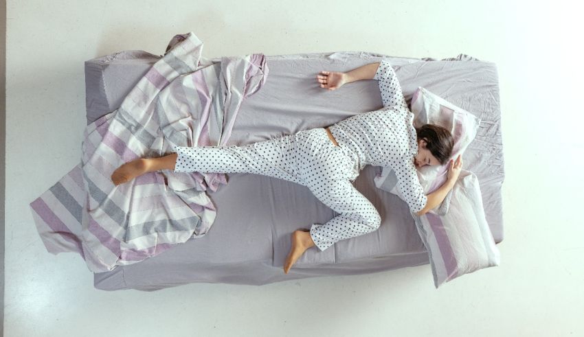 A woman laying on top of a bed.