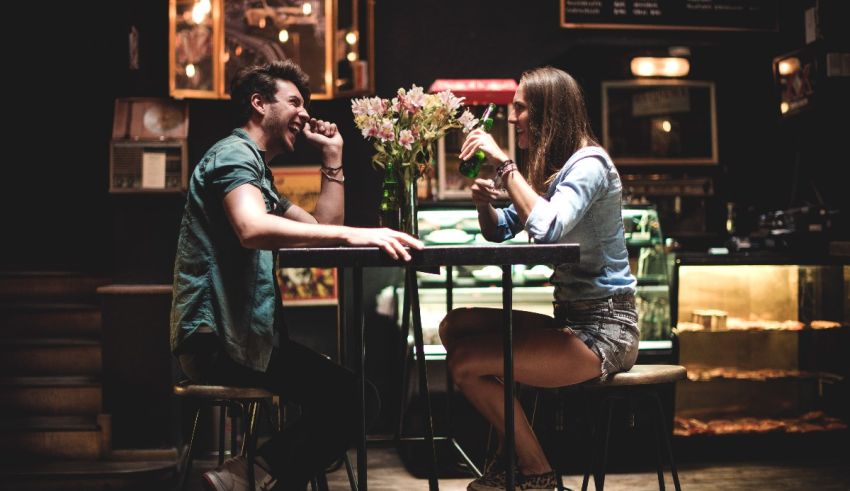 A man and woman sitting at a table in a restaurant.