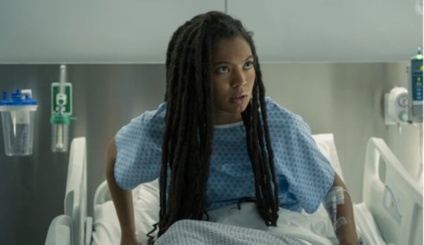 A woman in a hospital bed with dreadlocks.
