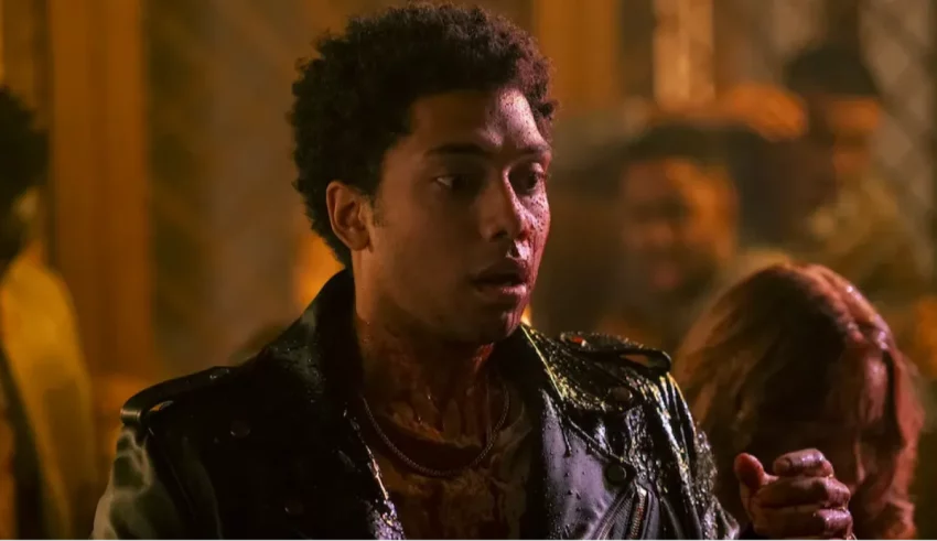 A man in a leather jacket with blood on his face.