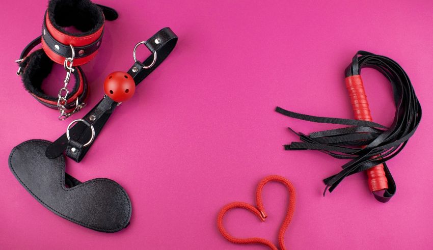 Sex toys and accessories on a pink background.