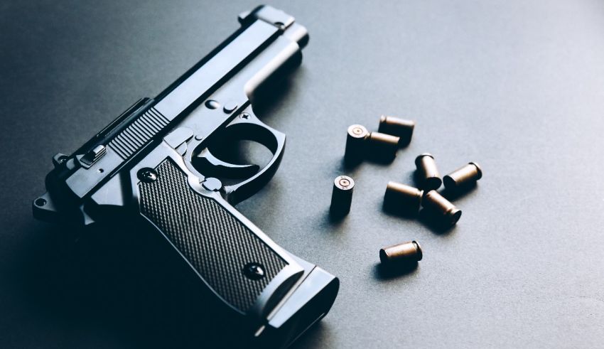 A gun and bullets on a dark background.