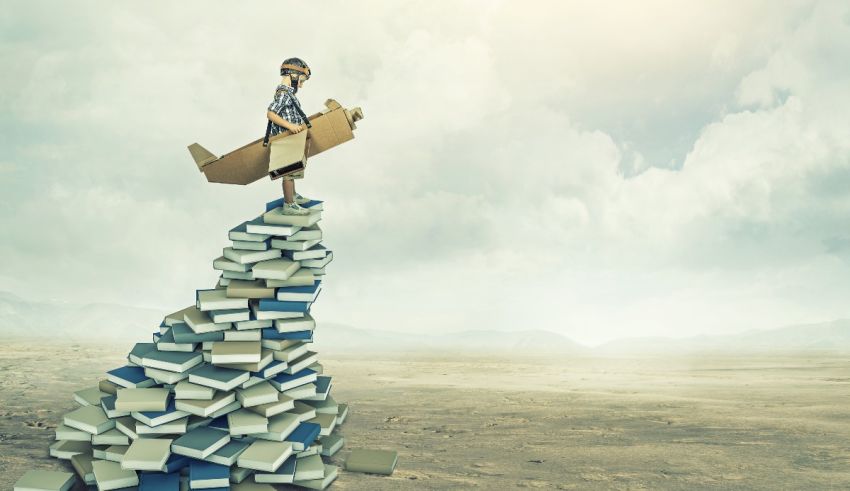 A man standing on top of a stack of books.