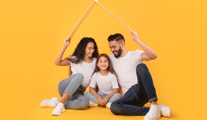 A family is sitting on a yellow background with a house in the shape of a house.