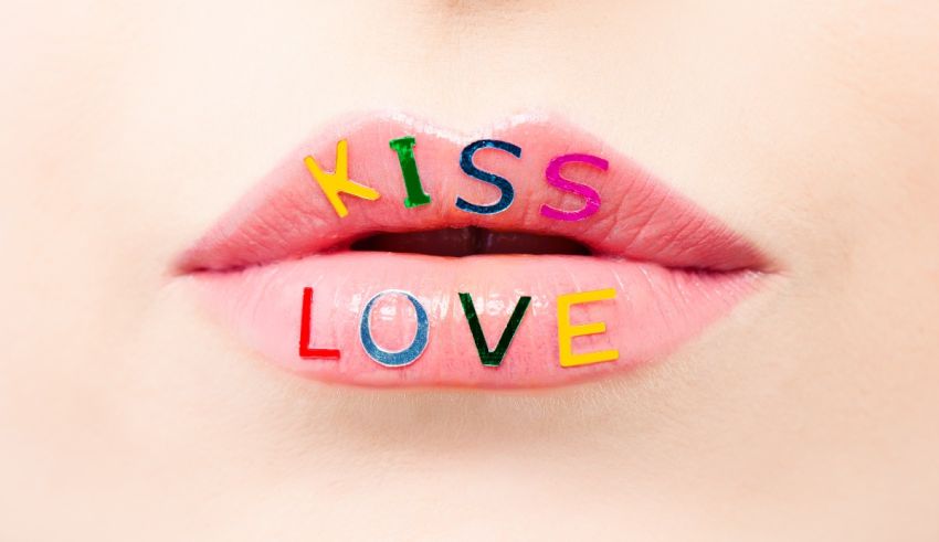 A woman's lips with the word kiss love written on them.
